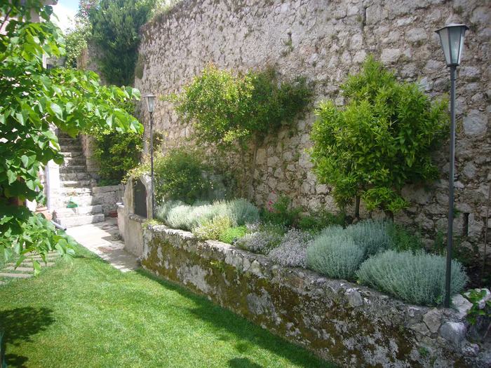 Aiuola di piante aromatiche lungo il muro